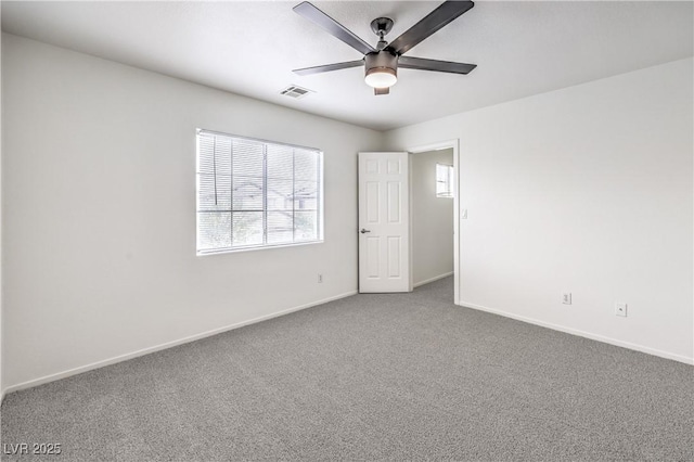 unfurnished room featuring ceiling fan, carpet flooring, baseboards, and visible vents
