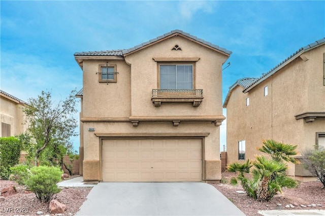 view of front of house featuring a garage, stucco siding, a tiled roof, and driveway