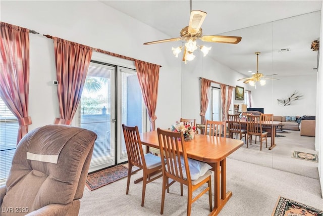 carpeted dining room with a ceiling fan