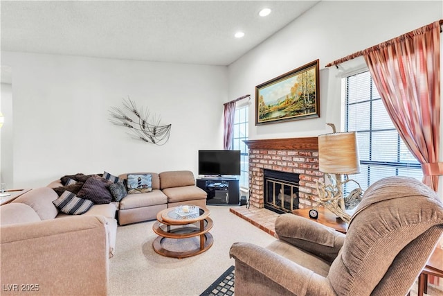 carpeted living room featuring recessed lighting and a fireplace