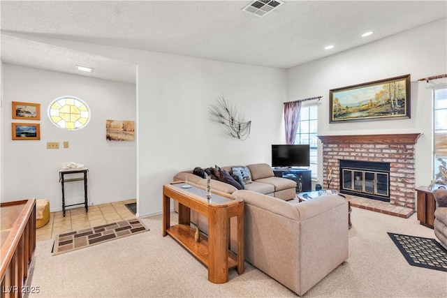 living area featuring light colored carpet, plenty of natural light, a fireplace, and recessed lighting