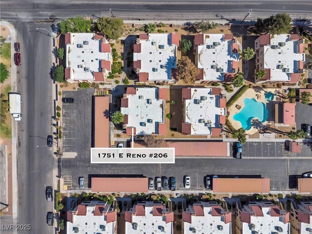 aerial view of property and surrounding area with a pool area