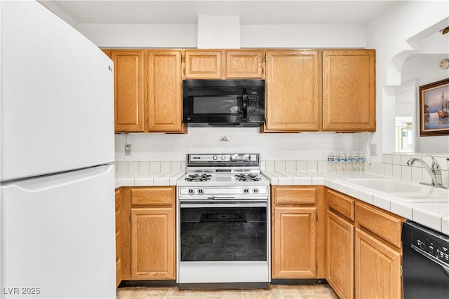 kitchen with black appliances and a sink