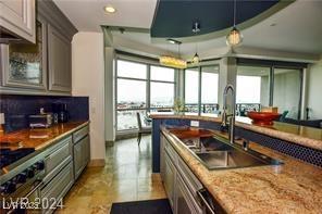 9101 Alta Dr Unit 507, Las Vegas, NV 89145 - kitchen featuring a sink, healthy amount of natural light, recessed lighting, light stone counters, and pendant lighting