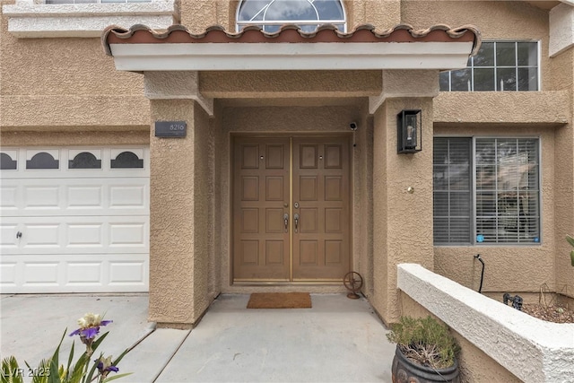 doorway to property featuring stucco siding
