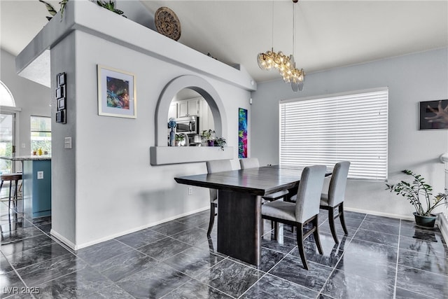 dining space with vaulted ceiling, baseboards, a chandelier, and dark marble finish flooring
