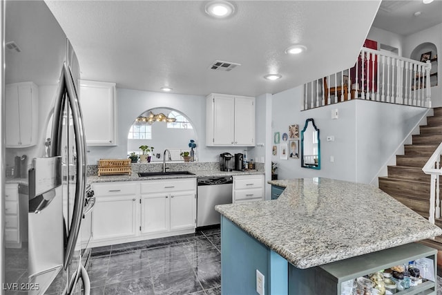 kitchen featuring a sink, stainless steel appliances, light stone counters, a center island, and recessed lighting
