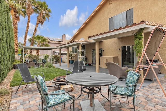 view of patio with a fire pit and a fenced backyard