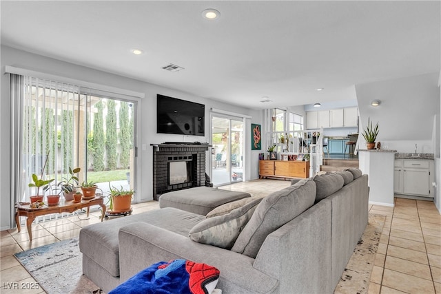 living room with a fireplace, light tile patterned flooring, and recessed lighting