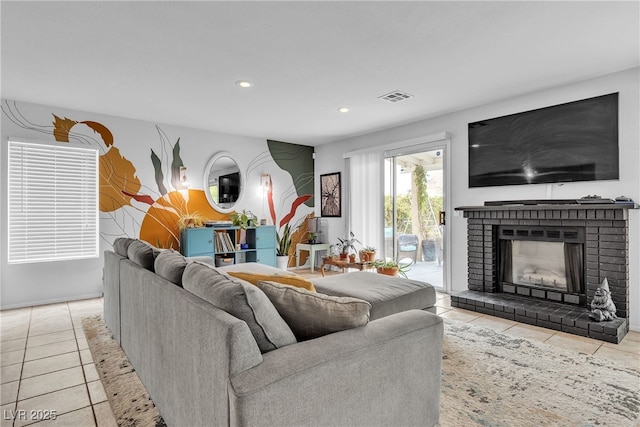 tiled living area with a fireplace and recessed lighting