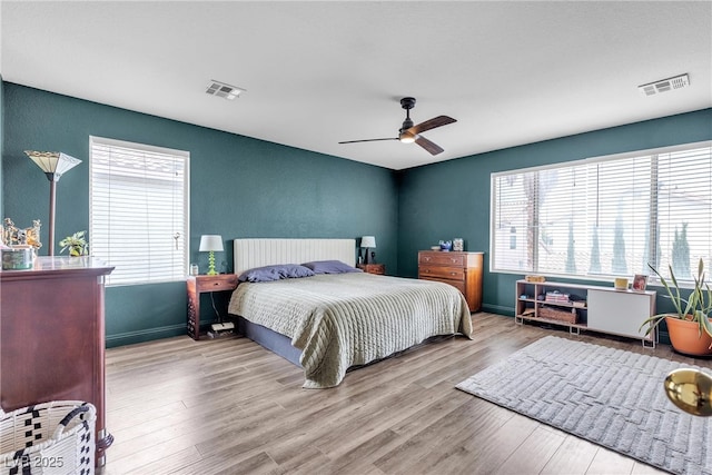 bedroom featuring wood finished floors, ceiling fan, and baseboards
