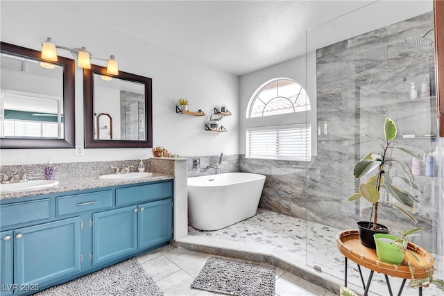 bathroom featuring walk in shower, double vanity, a freestanding tub, and tile patterned flooring