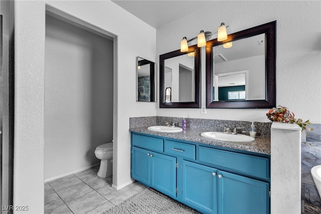 bathroom with toilet and double vanity