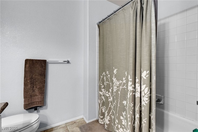 bathroom featuring toilet and baseboards