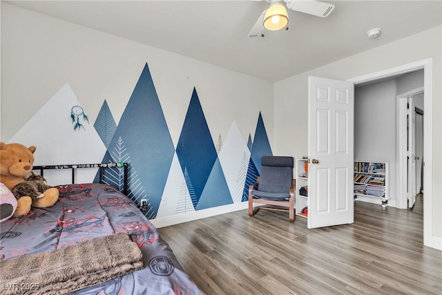 bedroom with wood finished floors and baseboards