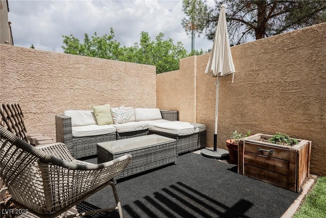 view of patio / terrace featuring an outdoor living space and fence