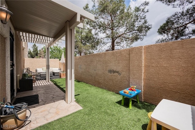 view of yard with an outdoor living space and a patio