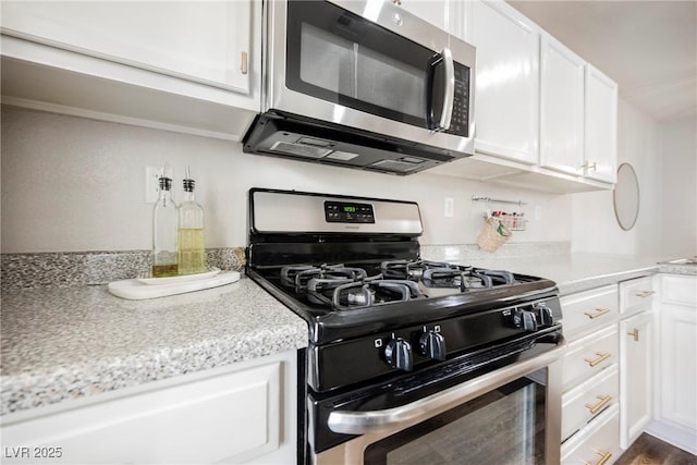 kitchen with stainless steel appliances and white cabinets