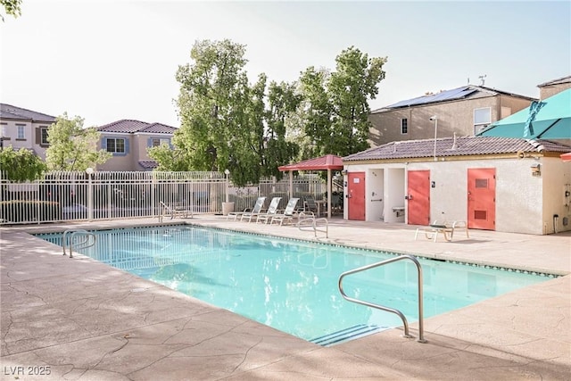 community pool featuring a patio area and fence