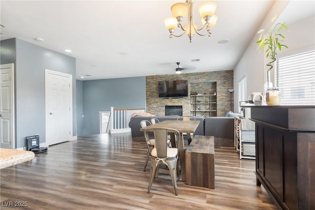 dining room with wood finished floors, ceiling fan, a chandelier, recessed lighting, and built in shelves