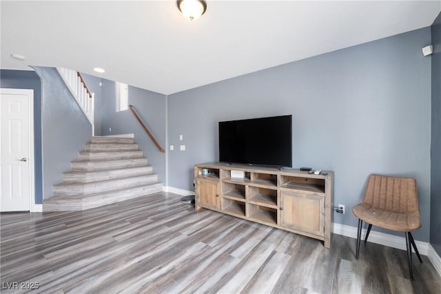 living room with stairway, baseboards, and wood finished floors