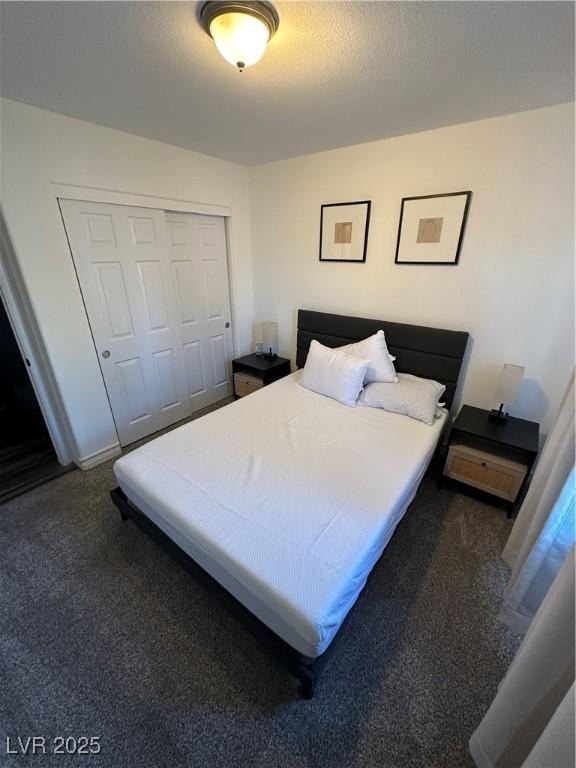 bedroom featuring dark carpet and a closet