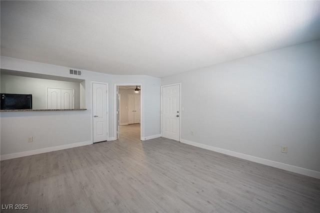 5055 W Hacienda Ave Unit 1097, Las Vegas, NV 89118 - unfurnished living room featuring wood finished floors and baseboards