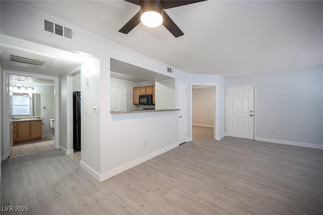 5055 W Hacienda Ave Unit 1097, Las Vegas, NV 89118 - unfurnished living room with light wood-type flooring, a ceiling fan, and baseboards