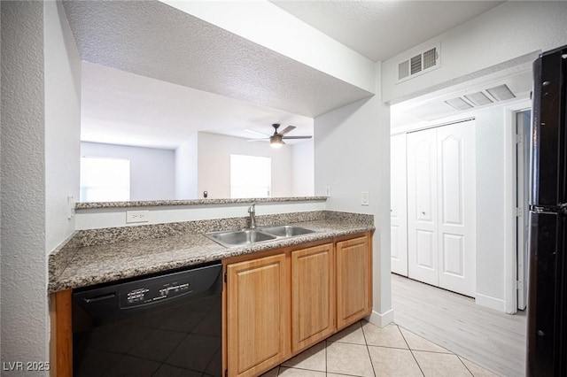 5055 W Hacienda Ave Unit 1097, Las Vegas, NV 89118 - kitchen with black dishwasher, a sink, ceiling fan, and light tile patterned floors