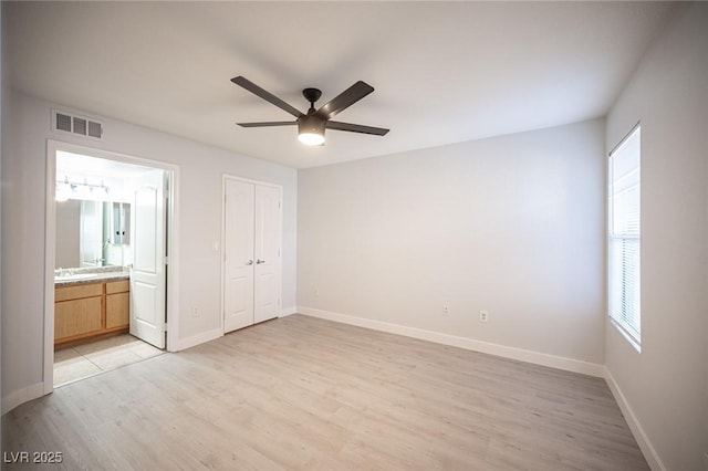 5055 W Hacienda Ave Unit 1097, Las Vegas, NV 89118 - unfurnished bedroom with light wood-type flooring, baseboards, ensuite bathroom, and a closet
