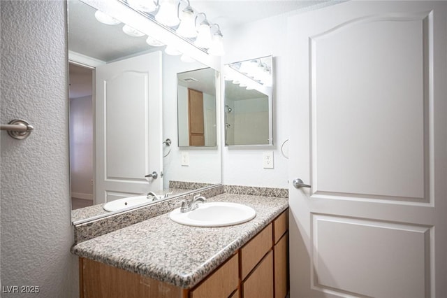 5055 W Hacienda Ave Unit 1097, Las Vegas, NV 89118 - bathroom with vanity and a textured wall