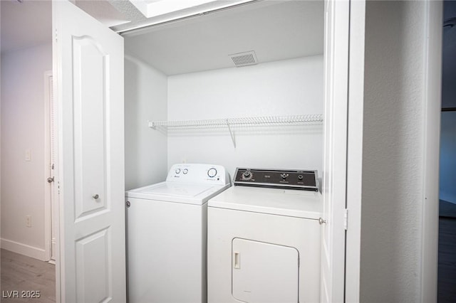 5055 W Hacienda Ave Unit 1097, Las Vegas, NV 89118 - laundry room featuring washer and dryer, wood finished floors, and baseboards