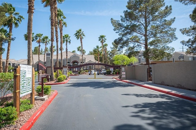 5055 W Hacienda Ave Unit 1097, Las Vegas, NV 89118 - view of asphalt street featuring a gate, a gated entry, a residential view, and curbs
