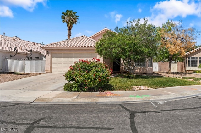 4517 Rodman Dr, Las Vegas, NV 89130 - view of front of home with a garage, a tile roof, fence, driveway, and a gate