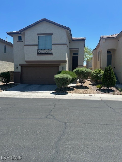 view of front of property featuring a garage, driveway, and stucco siding
