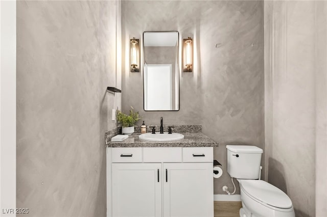 bathroom featuring toilet and vanity