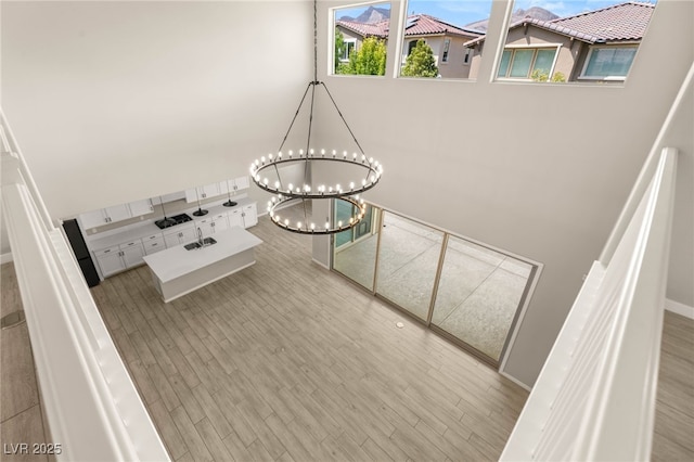 stairs with a chandelier and wood finished floors