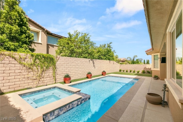 view of swimming pool with a fenced backyard, a patio, and a pool with connected hot tub
