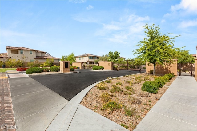 view of front of home featuring a gate, fence, and a residential view