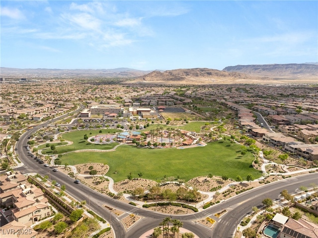 aerial view of property and surrounding area with nearby suburban area and mountains