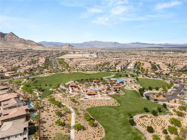 view of property location featuring a mountain backdrop and nearby suburban area