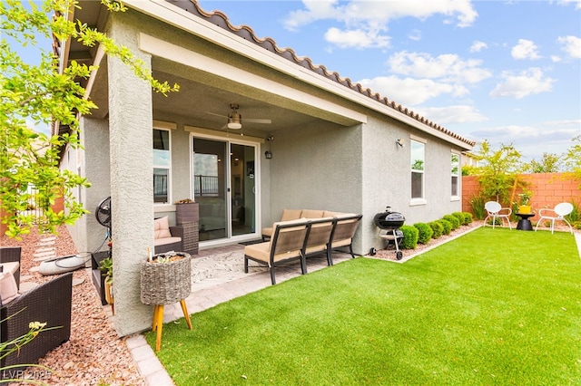 rear view of house featuring an outdoor living space, stucco siding, a ceiling fan, and a patio area