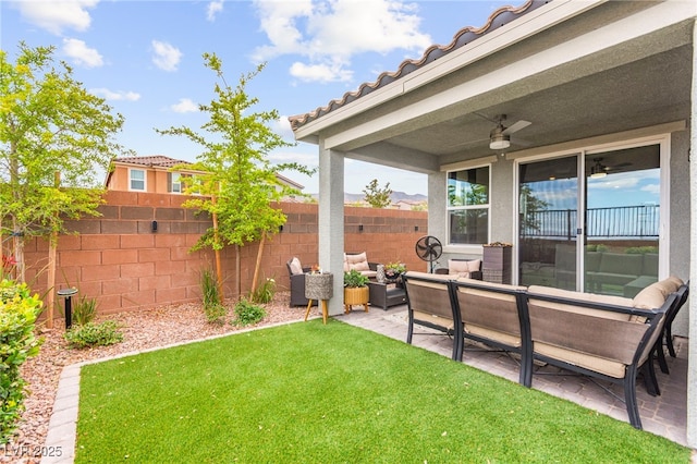 view of yard featuring an outdoor hangout area, a patio, and a ceiling fan