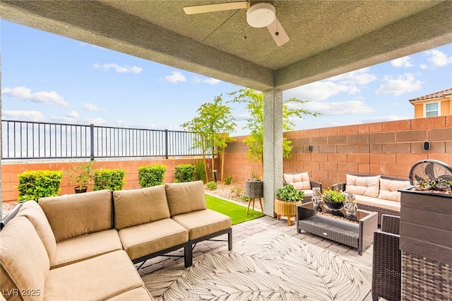 view of patio with outdoor lounge area, a fenced backyard, ceiling fan, and a water view