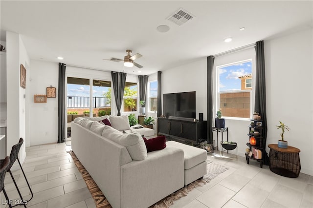 living room featuring healthy amount of natural light, a ceiling fan, recessed lighting, and light tile patterned flooring