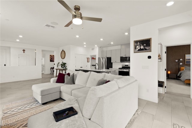 living room with a ceiling fan and recessed lighting