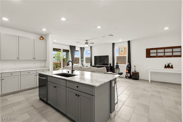 kitchen with a sink, gray cabinets, dishwasher, ceiling fan, and a center island with sink