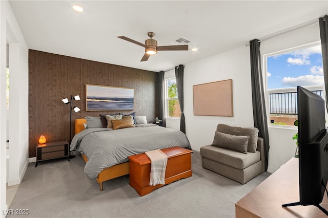 bedroom with light carpet, ceiling fan, recessed lighting, wood walls, and baseboards