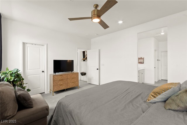 bedroom with light carpet, recessed lighting, a ceiling fan, and connected bathroom
