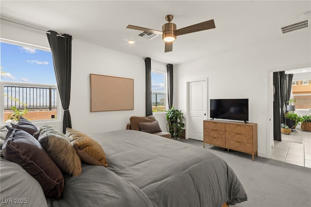 carpeted bedroom featuring tile patterned floors and a ceiling fan